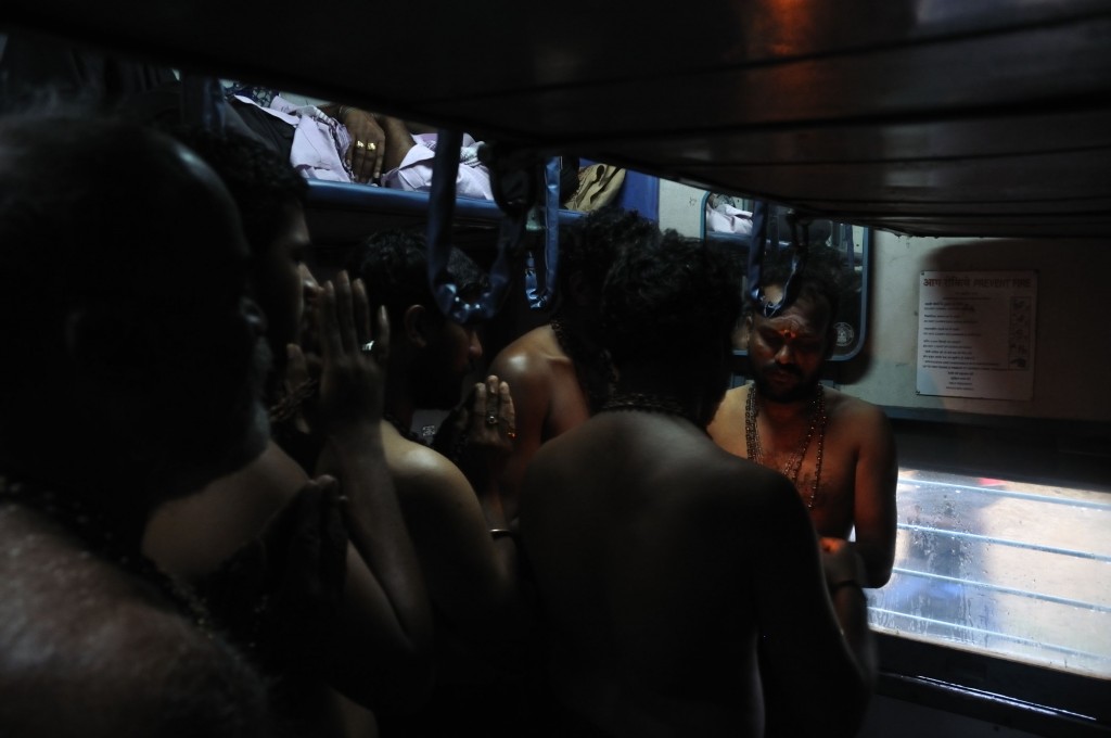 Pilgrims to Sabarimala say their evening prayers in the train